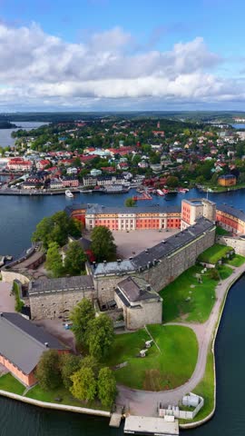 vertical aerial view of Vaxholm city in Sweden, Stockholm archipelago, Swedish medieval fortress in Scandinavia, tourism in Sweden, drone view of Vaxholm castle