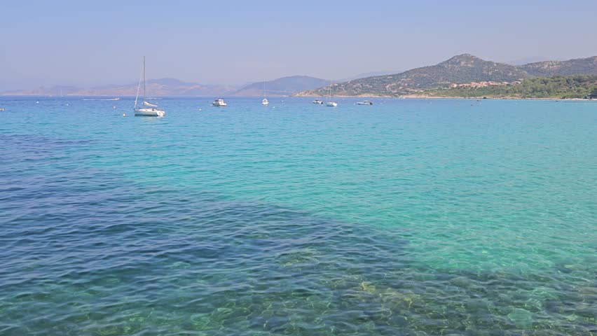Stunning aerial view of turquoise blue water at Ile Rousse, Corsica, France. High quality 8K footage