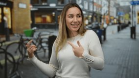 Young woman dancing joyfully on a lively urban street with blurred background, expressing happiness and energy outdoors during daylight. - Powered by Shutterstock - Get 15% off with code: PIKWIZARD15