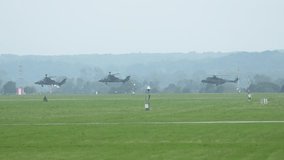 Military helicopters fly in formation during training on a clear day - Powered by Shutterstock - Get 15% off with code: PIKWIZARD15