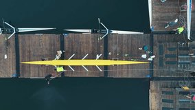 Top View Of Rowing Boat Crews Disembarking After Training. They Carry Rowboats And Oars, Showing Teamwork, Strength, And Post-Workout Routine On The Pier In Halifax Bay. - Powered by Shutterstock - Get 15% off with code: PIKWIZARD15