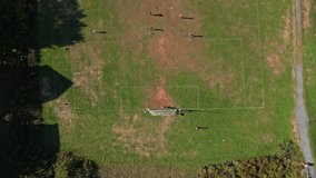 Top View Teens In Sportswear Running Across The Grass, Shooting Goals, And Passing The Ball. Energetic Football Training Captured From Above On A Clear Day In Halifax. - Powered by Shutterstock - Get 15% off with code: PIKWIZARD15