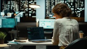 Employee monitors live stock market trends and cryptocurrency exchanges, leveraging technology and professional analysis to achieve trading objectives and optimize revenue. Night time. Camera B. - Powered by Shutterstock - Get 15% off with code: PIKWIZARD15