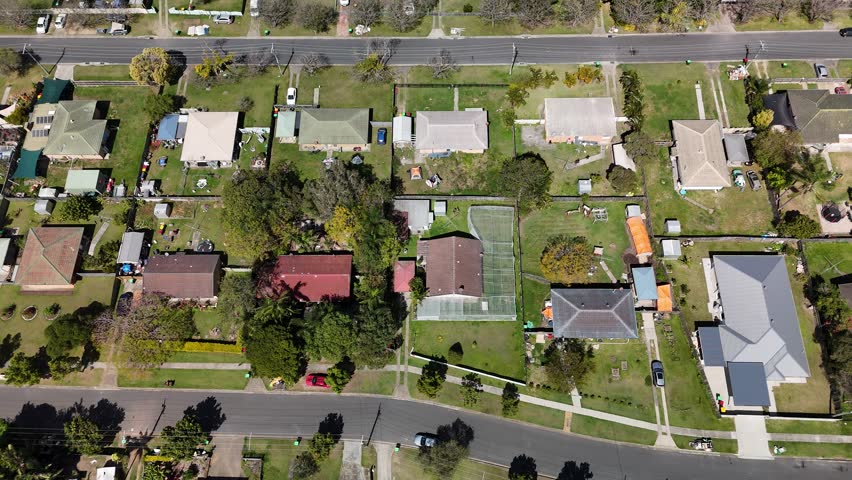 4K Aerial Footage of Ellen Grove Suburb, Queensland, Australia: Low-Density Housing with Solar, Tree Lined Streets, Suburban Layout, Residential Zone, and Urban Green Space in South-Western Brisbane
