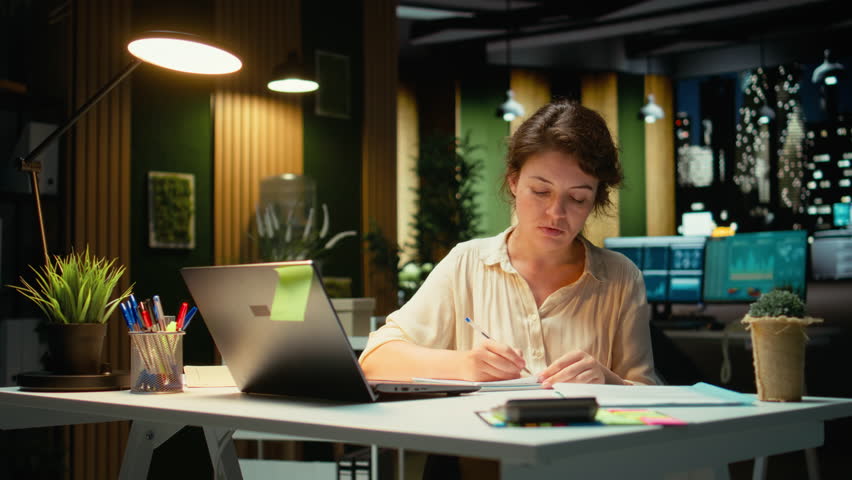 Corporate strategist ripping a paper after writing the wrong idea, restarting her work in rage and crumpling the page sheet, Discontent woman does a typo mistake while transcribing. Camera A.