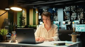 Woman joining a remote webinar from desk using laptop and headset, interacting with participants. Person maintaining eye contact, exchanging ideas in a chat that promotes networking. Camera A. - Powered by Shutterstock - Get 15% off with code: PIKWIZARD15