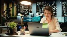 Businesswoman joins an online meeting at night in corporate office, maintaining eye contact with the camera. Manager focused on communication, participating in collaborative dialogue. Camera A. - Powered by Shutterstock - Get 15% off with code: PIKWIZARD15