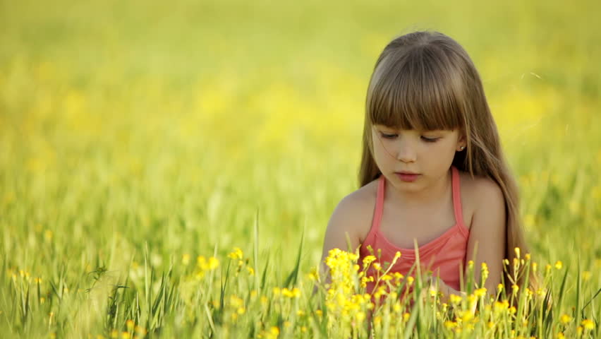 Girl enjoying the scent of flowers
