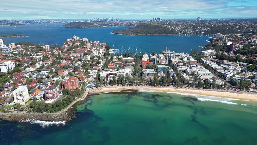 Sydney, Australia : Tilt up and downward footage of Manly beach and its seaside resort area. Located in northern Sydney, New South Wales, Australia