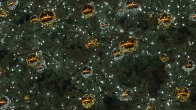 Close up of Christmas tree decorated with golden and silver baubles and twinkling lights at night. Concept of winter holiday, festive mood and seasonal celebration - Powered by Shutterstock - Get 15% off with code: PIKWIZARD15