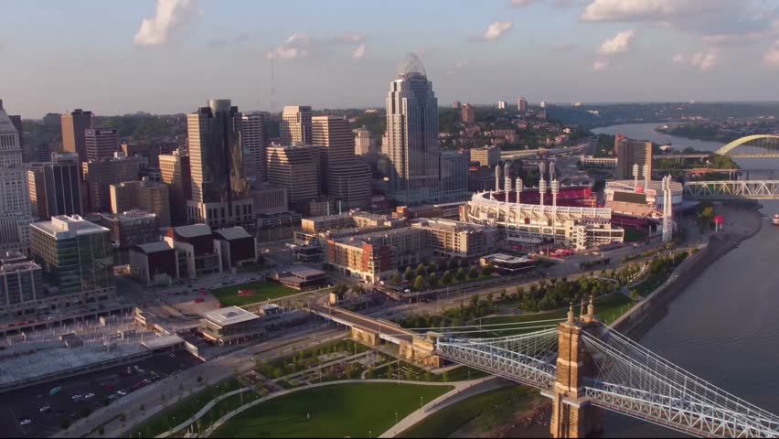 The aerial footage offers a broad, high-angle view of the Cincinnati, Ohio, skyline and the surrounding downtown area, captured at either sunset or sunrise