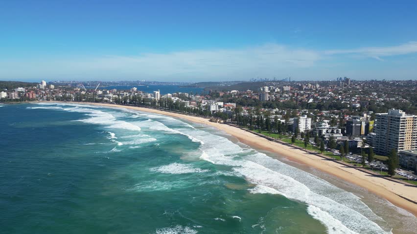 Sydney, Australia : Aerial drone footage of waves in Manly beach northern Sydney, New South Wales, Australia. Showing the seaside cliffhouse area with backward motion.  