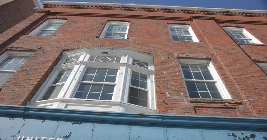 This is a shot of a post office Building in white river junction vermont which has a old red brick victorian style architecture. Shot in February 14th 2025