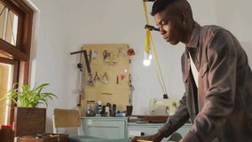 Craftsman smoothing and marking fabric measurements in workshop spawning animated data node network. Artisan, tailoring, digital integration, craftsmanship, innovation, workspace, modern - Powered by Shutterstock - Get 15% off with code: PIKWIZARD15