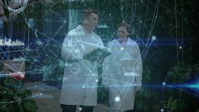 Scientists swiping tablet and showing data charts while inspecting greenhouse peppers for research. Botany, horticulture, research, innovation, technology, collaboration, modern - Powered by Shutterstock - Get 15% off with code: PIKWIZARD15