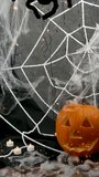 Pumpkin and black spider on a white web with flashing lights, Halloween holiday concept - Powered by Shutterstock - Get 15% off with code: PIKWIZARD15