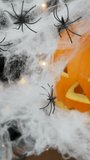 Many small spiders on a white web on Halloween against the background of a pumpkin - Powered by Shutterstock - Get 15% off with code: PIKWIZARD15