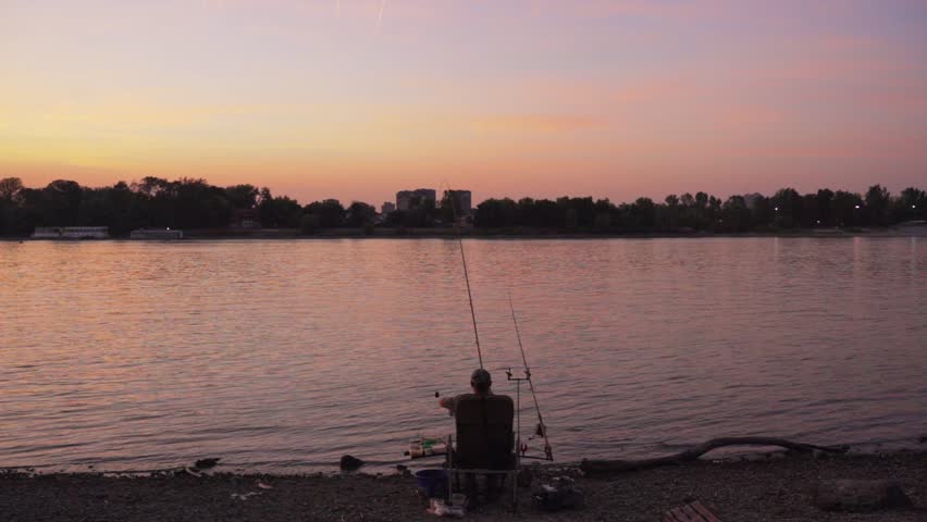 Serenity at sunset while fishing by the lake in a tranquil setting