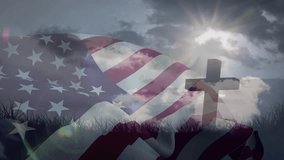 Sun-triggered American flag waving over static cross on grassy ridge, glinting flares looping. Patriotism, outdoors, symbolism, faith, heritage, nature, serenity - Powered by Shutterstock - Get 15% off with code: PIKWIZARD15