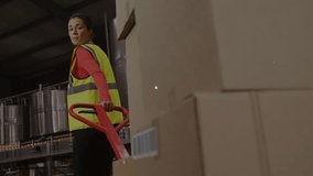 Warehouse worker moving boxes on pallet jack, glancing back, displaying icons forming logistics web. Industrial, logistics, connectivity, digital, warehouse, inventory, infrastructure - Powered by Shutterstock - Get 15% off with code: PIKWIZARD15