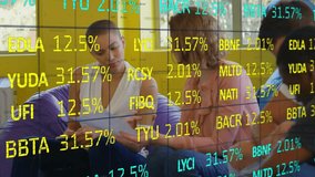 Colleagues tapping tablet and writing note causing percentage codes updating for business meeting. Collaboration, data analysis, workspace, innovation, teamwork, digital technology, brainstorming - Powered by Shutterstock - Get 15% off with code: PIKWIZARD15