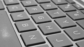 Close-up video of a QWERTY keyboard, capturing key details as fingers type across illuminated keys. - Powered by Shutterstock - Get 15% off with code: PIKWIZARD15
