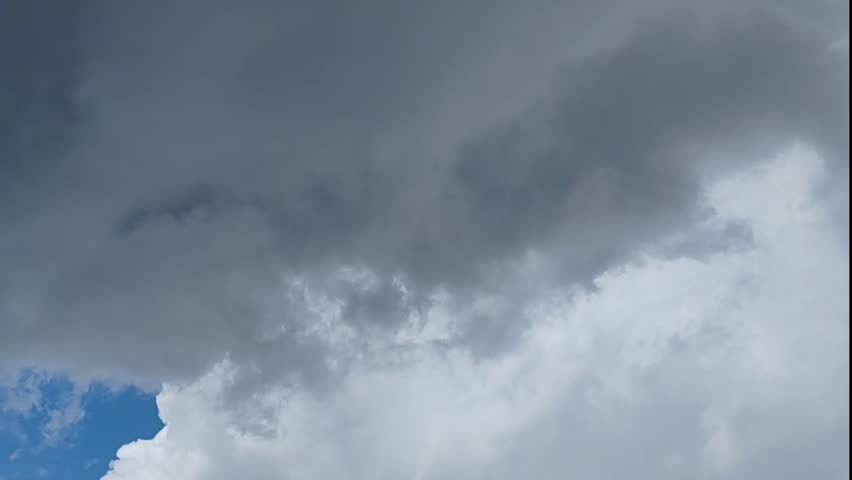 Storm clouds slowly passing across the Sri Lankan sky, revealing clearer skies and sunlight beyond. A powerful tropical weather scene capturing both the drama of the storm and the calm that follows. 