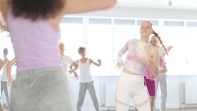 Girl teen performs modern dances repeats movements of unrecognizable teacher together with friends during lesson at choreographic school. Hobbies, active pastime - Powered by Shutterstock - Get 15% off with code: PIKWIZARD15