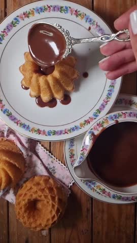 Vertical food video featuring a chocolate-covered cake. Combination of slow motion and classic video. Vintage styling.