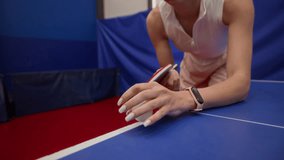 Focused young woman in sportswear tossing ball into air then serving slice shot during table tennis match in gym, slow motion - Powered by Shutterstock - Get 15% off with code: PIKWIZARD15