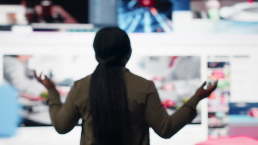 Woman looks at mixed videos mosaic mirroring modern media consumption habits. User enjoys social networks feedback and viral engagement highlighting modern digital lifestyle, camera B