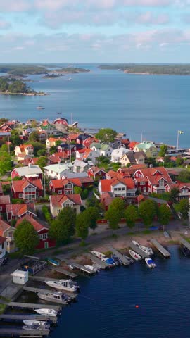 vertical aerial video of Swedish nature, drone view of Sandhamn island in Stockholm archipelago, traditional colourful houses on an island in the Baltic Sea in Sweden, Scandinavian nature. 