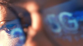 A close-up of a person’s eye with the 5G reflected in their glasses represents digital transformation, real-time connectivity, innovation in smart devices, and the changing way we access information.
 - Powered by Shutterstock - Get 15% off with code: PIKWIZARD15