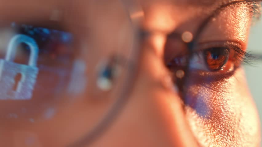 A person wearing glasses is reflected with a digital padlock, symbolizing data privacy, online security, personal information protection, and the significance of safeguarding digital identities.
