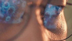 A person wearing glasses works on a laptop, with glowing reflections of viruses or bacteria in the lenses, symbolizing research, technology, health and broader conceptual ideas of science and society. - Powered by Shutterstock - Get 15% off with code: PIKWIZARD15