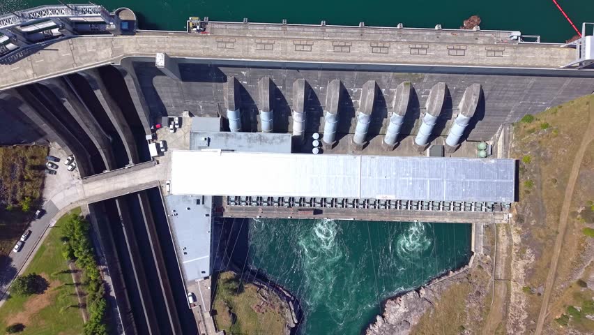Top down and rising drone footage encaptures alternative power production facility in New Zealand. Hydro Electric dam construction on the Clutha river one of New Zealand's biggest.