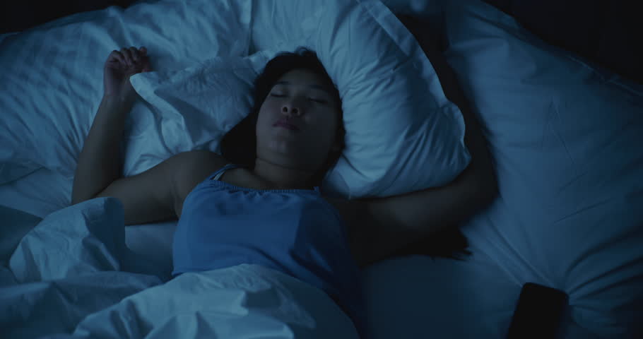 Asian Girl Suffering From Insomnia, Upset and Restless in Bed. She Tosses, Turns, and Struggles to Fall Asleep, Face Showing Stress, Anxiety, and Exhaustion. Concept of Poor Rest, Tension, Insomnia.