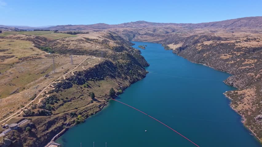 Encaptivating Aerial drone footage revealing a powerful, industrial hydroelectric dam producing renewable energy in New Zealand