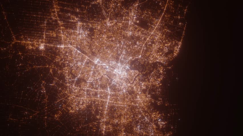 Bangkok (Thailand) top view at night. Top view on modern city with street lights and glow effect. Camera is zooming in, rotating clockwise. Vertical video. The north is on the left side