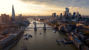 Beautiful, panoramic aerial view of the skyline of London, United Kingdom, along the Thames river with City and Tower bridge during golden sunset time - Powered by Shutterstock - Get 15% off with code: PIKWIZARD15