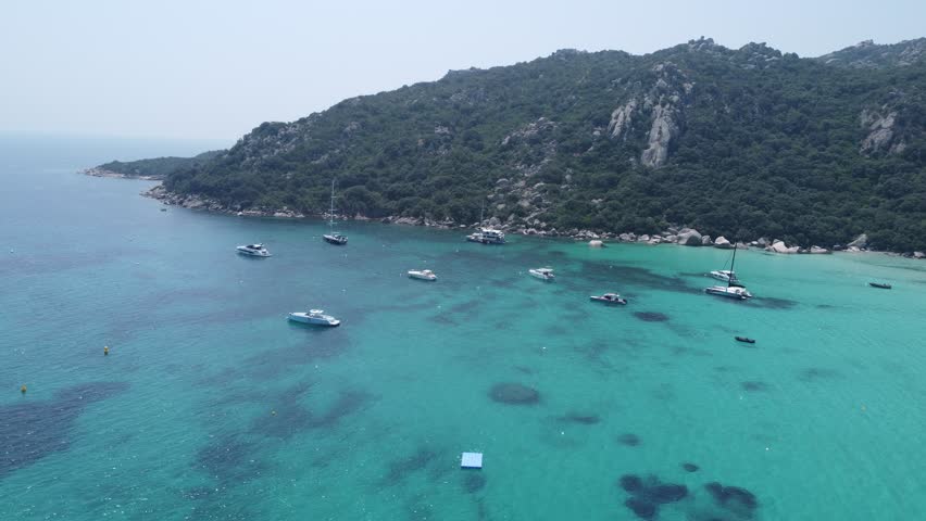 Boats in sea at Plage de Santa Giulia, Corsica