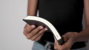 A person is holding an open book, with the pages fanned out. - Powered by Shutterstock - Get 15% off with code: PIKWIZARD15