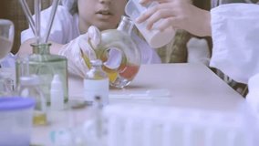 Foaming liquid demonstrating chemistry experiment, Children in protective gear, Young students prepare for hands-on lab work, scientific discovery and mixing chemical solutions - Powered by Shutterstock - Get 15% off with code: PIKWIZARD15