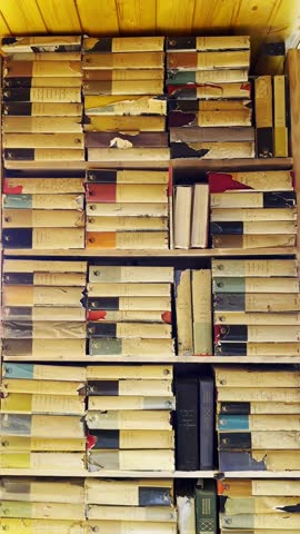 Moscow, Russia, 26.09.2025 Old books on a bookshelf showcasing vintage literature and knowledge. Retro library interior concept for historical research footage.
