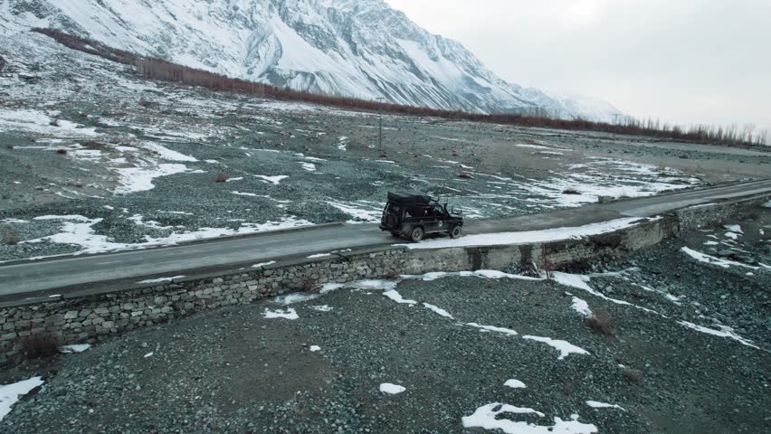 Beautiful drone view of road and valley in Gilgit Baltistan, Pakistan. Beautiful snow capped mountains, beautiful valleys, cloudy weather, spa nature, northern area of Pakistan, travelling, beauty. 