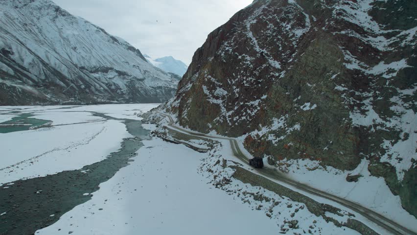 Beautiful drone view of road and valley in Gilgit Baltistan, Pakistan. Beautiful snow capped mountains, beautiful valleys, cloudy weather, spa nature, northern area of Pakistan, travelling, beauty. 