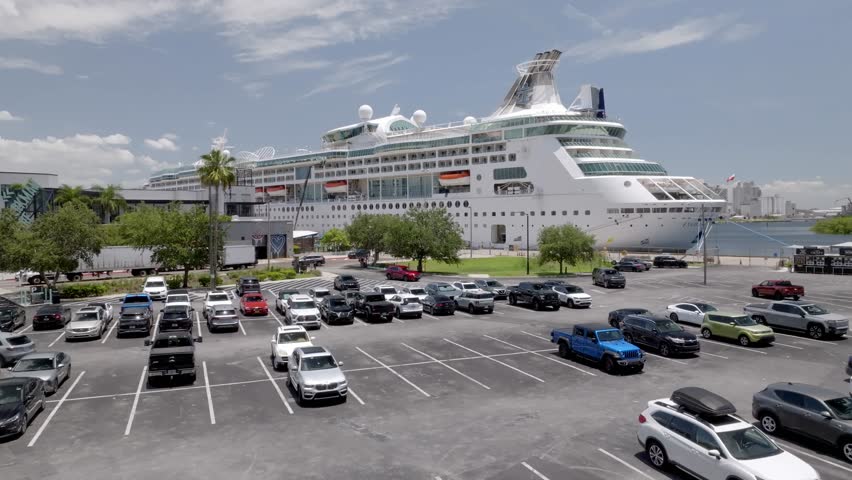 Cruise ship docked in Tampa, Florida with drone video moving up.