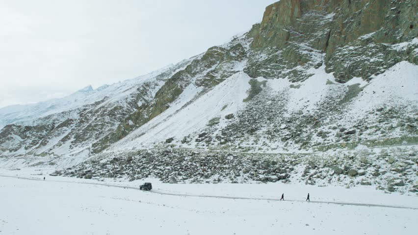 Beautiful drone view of road and valley in Gilgit Baltistan, Pakistan. Beautiful snow capped mountains, beautiful valleys, cloudy weather, spa nature, northern area of Pakistan, travelling, beauty. 