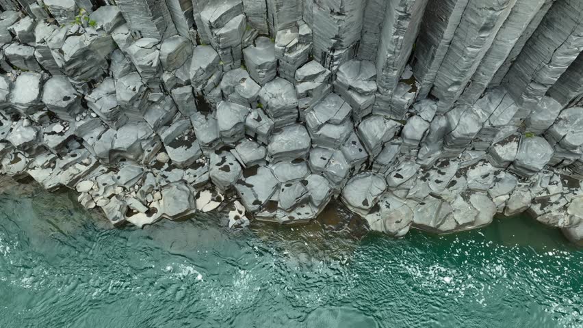 Aerial top down of famous Studlagil canyon formation and green water in Iceland, Europe. Flowing river slowly in scenic area.