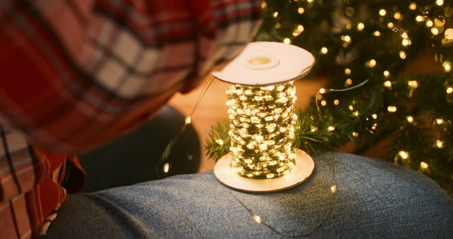 Decorating Christmas Tree with Lights and Ornaments at Home